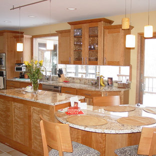 Design ideas for a large eclectic galley eat-in kitchen in Cleveland with an undermount sink, shaker cabinets, light wood cabinets, granite benchtops, window splashback, stainless steel appliances, porcelain floors, multiple islands and beige floor.