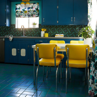 This is an example of a mid-sized midcentury u-shaped kitchen in San Francisco with an undermount sink, flat-panel cabinets, blue cabinets, quartz benchtops, blue splashback, cement tile splashback, stainless steel appliances, porcelain floors, no island, blue floor and grey benchtop.