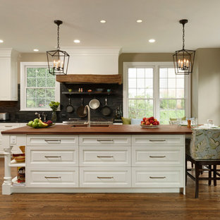 Large traditional eat-in kitchen designs - Example of a large classic l-shaped medium tone wood floor eat-in kitchen design in DC Metro with an undermount sink, white cabinets, wood countertops, paneled appliances, an island, beaded inset cabinets, gray backsplash and mosaic tile backsplash