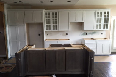 Kitchen - kitchen idea in Detroit with shaker cabinets, white cabinets and an island