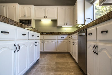 Example of a mid-sized transitional u-shaped ceramic tile and beige floor eat-in kitchen design in San Francisco with a drop-in sink, raised-panel cabinets, white cabinets, granite countertops, stainless steel appliances and an island