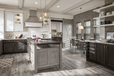 Inspiration for a large transitional u-shaped light wood floor and brown floor eat-in kitchen remodel in San Francisco with an undermount sink, recessed-panel cabinets, dark wood cabinets, wood countertops, white backsplash, ceramic backsplash, stainless steel appliances and an island