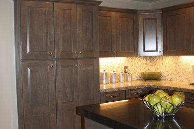 Example of a transitional kitchen design in Portland Maine with raised-panel cabinets and gray cabinets