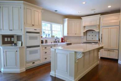 Kitchen photo in Chicago with white cabinets, marble countertops and white countertops