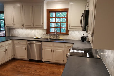 Inspiration for a mid-sized contemporary u-shaped eat-in kitchen remodel in Raleigh with white cabinets, stainless steel appliances and an island