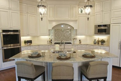 Large elegant u-shaped medium tone wood floor eat-in kitchen photo in Cincinnati with raised-panel cabinets, white cabinets, granite countertops and an island