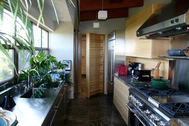 Example of a mid-sized kitchen design in Portland Maine with flat-panel cabinets, medium tone wood cabinets and granite countertops