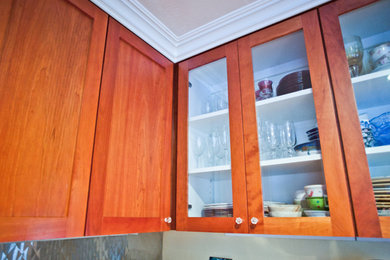 Photo of a kitchen in San Francisco with flat-panel cabinets and medium wood cabinets.