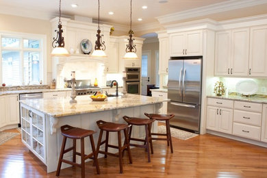 Large elegant l-shaped medium tone wood floor eat-in kitchen photo in Other with raised-panel cabinets, white cabinets, granite countertops, stainless steel appliances and an island