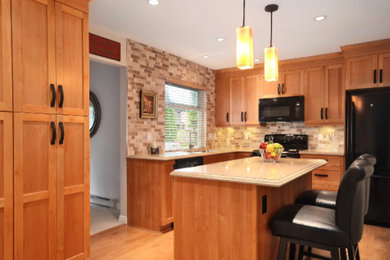 Mid-sized trendy u-shaped medium tone wood floor and brown floor enclosed kitchen photo in Vancouver with a double-bowl sink, shaker cabinets, medium tone wood cabinets, laminate countertops, beige backsplash, brick backsplash, black appliances and an island