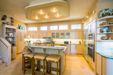 This is an example of a large midcentury u-shaped open plan kitchen in Denver with a double-bowl sink, flat-panel cabinets, light wood cabinets, granite worktops, green splashback, matchstick tiled splashback, stainless steel appliances, ceramic flooring, an island and beige floors.