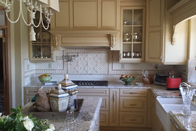 Eat-in kitchen - mid-sized traditional u-shaped light wood floor eat-in kitchen idea in Other with raised-panel cabinets, granite countertops, stainless steel appliances, an island, a farmhouse sink, white cabinets, beige backsplash and ceramic backsplash