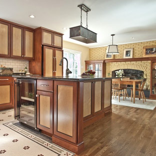 Rustic eat-in kitchen ideas - Mountain style eat-in kitchen photo in DC Metro with recessed-panel cabinets, medium tone wood cabinets, white backsplash, subway tile backsplash and paneled appliances