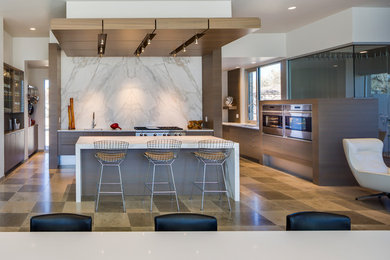 Inspiration for a contemporary kitchen remodel in Albuquerque with flat-panel cabinets, marble countertops, stone slab backsplash and stainless steel appliances