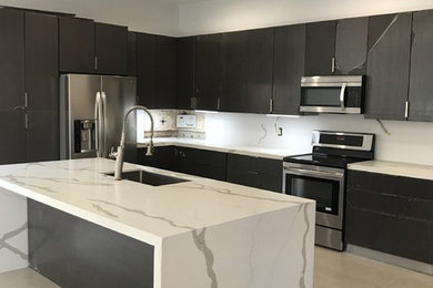 Large trendy galley eat-in kitchen photo in Miami with quartz countertops and an island