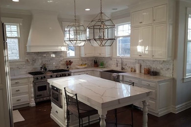 Eat-in kitchen - mid-sized transitional u-shaped dark wood floor eat-in kitchen idea in Chicago with a farmhouse sink, raised-panel cabinets, white cabinets, marble countertops, white backsplash, marble backsplash, stainless steel appliances and an island