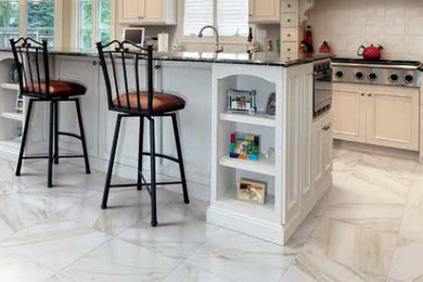Large minimalist single-wall marble floor eat-in kitchen photo in Detroit with an undermount sink, recessed-panel cabinets, white cabinets, quartzite countertops, subway tile backsplash, stainless steel appliances and an island
