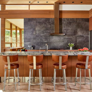Design ideas for a midcentury eat-in kitchen in Other with flat-panel cabinets, medium wood cabinets, grey splashback, stainless steel appliances, light hardwood floors, with island, beige floor and grey benchtop.