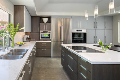 Inspiration for a mid-sized contemporary u-shaped porcelain tile and brown floor eat-in kitchen remodel in San Diego with a triple-bowl sink, flat-panel cabinets, dark wood cabinets, quartz countertops, white backsplash, porcelain backsplash, stainless steel appliances, an island and white countertops