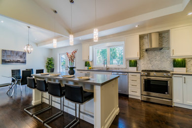 Example of a dark wood floor kitchen design in Toronto with quartzite countertops, gray backsplash, stainless steel appliances, an island and gray countertops