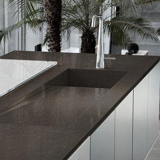Contemporary kitchen pictures - Trendy kitchen photo in Other with quartz countertops and an island