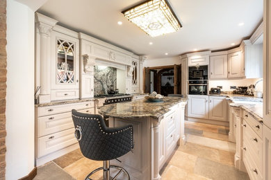 Photo of a large u-shaped open plan kitchen in Hertfordshire with shaker cabinets, quartz worktops and multiple islands.