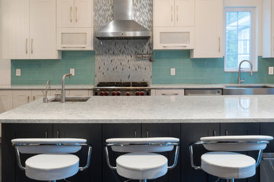 Large trendy u-shaped vinyl floor and gray floor eat-in kitchen photo in Philadelphia with a farmhouse sink, shaker cabinets, white cabinets, marble countertops, blue backsplash, glass tile backsplash, stainless steel appliances and two islands