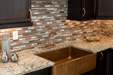 Trendy kitchen photo in Richmond with a farmhouse sink, recessed-panel cabinets, dark wood cabinets, quartzite countertops, multicolored backsplash and matchstick tile backsplash