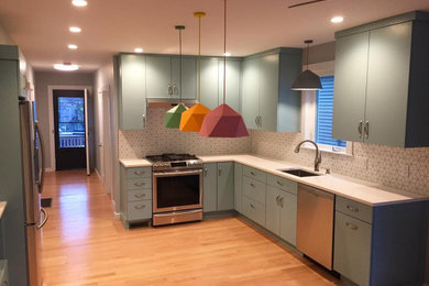 Eat-in kitchen - mid-sized modern u-shaped light wood floor and beige floor eat-in kitchen idea in Boston with an undermount sink, flat-panel cabinets, blue cabinets, marble countertops, multicolored backsplash, ceramic backsplash, stainless steel appliances, no island and white countertops