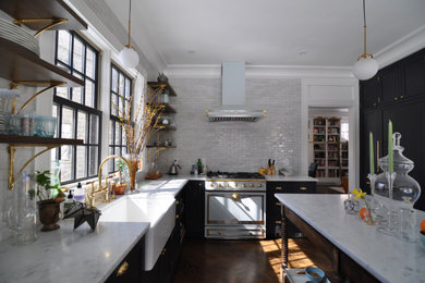 Large elegant l-shaped dark wood floor and brown floor eat-in kitchen photo in Boston with a farmhouse sink, shaker cabinets, black cabinets, marble countertops, gray backsplash, ceramic backsplash, paneled appliances, an island and white countertops