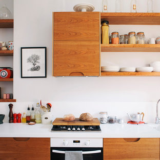 Inspiration for a medium sized retro single-wall kitchen in London with a double-bowl sink, flat-panel cabinets, white cabinets, quartz worktops, white appliances and white worktops.