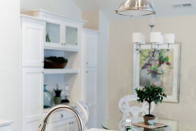 Example of a beach style kitchen design in Grand Rapids with a double-bowl sink
