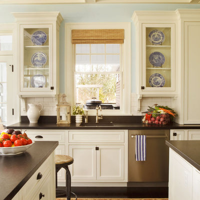 Huge elegant dark wood floor eat-in kitchen photo in Portland with glass-front cabinets, stainless steel appliances, granite countertops, a single-bowl sink, white cabinets, white backsplash, ceramic backsplash and two islands