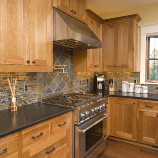Photo of a traditional kitchen in Seattle with stainless steel appliances, slate splashback and black benchtop.