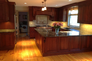 Large country u-shaped light wood floor eat-in kitchen photo in Portland Maine with an undermount sink, raised-panel cabinets, medium tone wood cabinets, granite countertops, blue backsplash, porcelain backsplash, stainless steel appliances and a peninsula