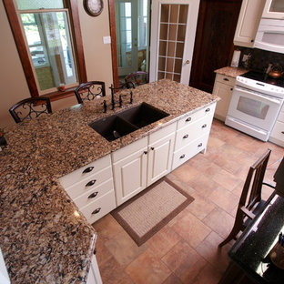 This is an example of a medium sized farmhouse galley enclosed kitchen in Toronto with a double-bowl sink, beaded cabinets, white cabinets, granite worktops, grey splashback, mosaic tiled splashback, white appliances, cement flooring, an island, orange floors and brown worktops.