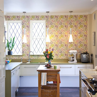 Design ideas for a large eclectic u-shaped kitchen in Cardiff with flat-panel cabinets, white cabinets, solid surface benchtops, porcelain floors, brown floor, an undermount sink and white appliances.