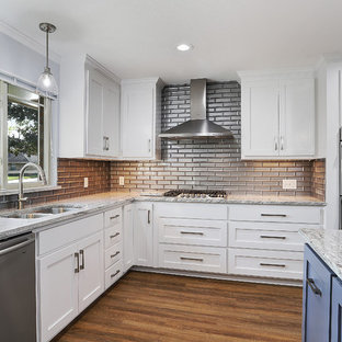 Large transitional open concept kitchen pictures - Large transitional u-shaped vinyl floor and brown floor open concept kitchen photo in New Orleans with a single-bowl sink, shaker cabinets, white cabinets, granite countertops, gray backsplash, glass tile backsplash, stainless steel appliances, an island and white countertops