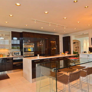 Design ideas for an expansive galley open plan kitchen in Other with a single-bowl sink, flat-panel cabinets, dark wood cabinets, solid surface benchtops, beige splashback, glass tile splashback, stainless steel appliances, porcelain floors and multiple islands.