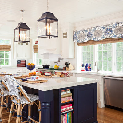 Kitchen - coastal single-wall medium tone wood floor kitchen idea in Boston with white cabinets, white backsplash, stainless steel appliances, an island, an undermount sink and shaker cabinets