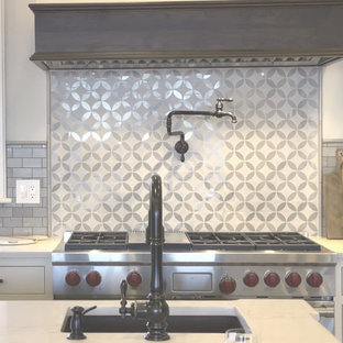 This is an example of a large transitional l-shaped kitchen pantry in Boston with an integrated sink, recessed-panel cabinets, white cabinets, quartz benchtops, brown splashback, ceramic splashback, stainless steel appliances, light hardwood floors, with island and yellow benchtop.