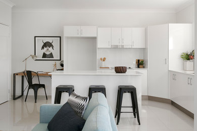 Inspiration for a modern l-shaped kitchen/diner in Brisbane with a double-bowl sink, white cabinets, engineered stone countertops, white splashback, ceramic splashback, stainless steel appliances and porcelain flooring.