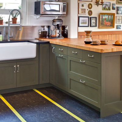 Transitional kitchen photo in Seattle with a farmhouse sink, shaker cabinets, green cabinets and wood countertops
