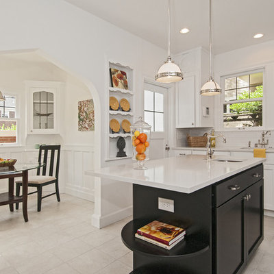 Eat-in kitchen - traditional eat-in kitchen idea in Seattle with an undermount sink, white cabinets, white backsplash, subway tile backsplash and stainless steel appliances