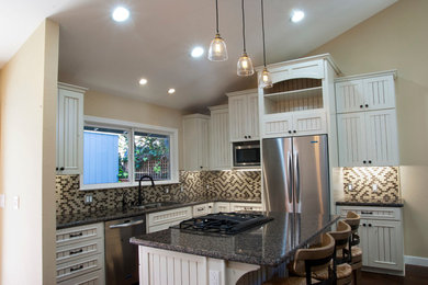 Inspiration for a small contemporary l-shaped medium tone wood floor eat-in kitchen remodel in San Francisco with an undermount sink, beaded inset cabinets, white cabinets, granite countertops, multicolored backsplash, stainless steel appliances and an island