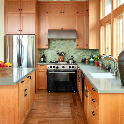 Inspiration for a mid-sized transitional l-shaped medium tone wood floor eat-in kitchen remodel in San Francisco with shaker cabinets, medium tone wood cabinets, green backsplash, matchstick tile backsplash, stainless steel appliances, an undermount sink, quartz countertops and an island