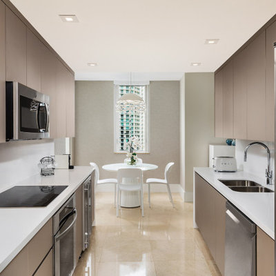 Small trendy marble floor and beige floor kitchen photo in Miami with flat-panel cabinets, brown cabinets, quartzite countertops, white backsplash, quartz backsplash, no island and white countertops