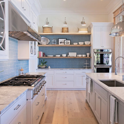 Eat-in kitchen - large transitional l-shaped medium tone wood floor eat-in kitchen idea in Atlanta with an undermount sink, shaker cabinets, white cabinets, quartz countertops, blue backsplash, subway tile backsplash, paneled appliances and an island