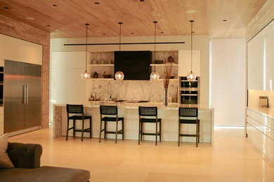 Example of a large minimalist open concept kitchen design in Los Angeles with flat-panel cabinets, white cabinets and an island