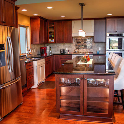 Open concept kitchen - mid-sized craftsman l-shaped dark wood floor open concept kitchen idea in Other with a double-bowl sink, shaker cabinets, dark wood cabinets, granite countertops, beige backsplash, porcelain backsplash, stainless steel appliances and an island